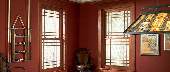 Red-walled room with custom windows with prairie grids